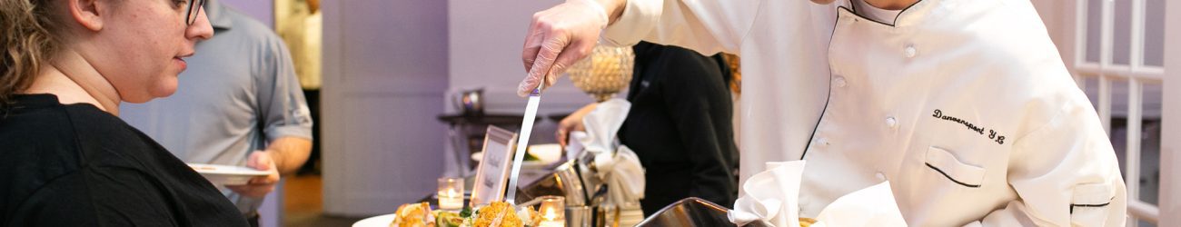 A chef at Danversport serves food from the buffet line