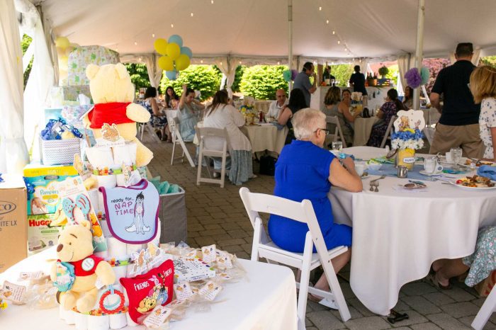 People celebrating at a tented baby shower at Danversport