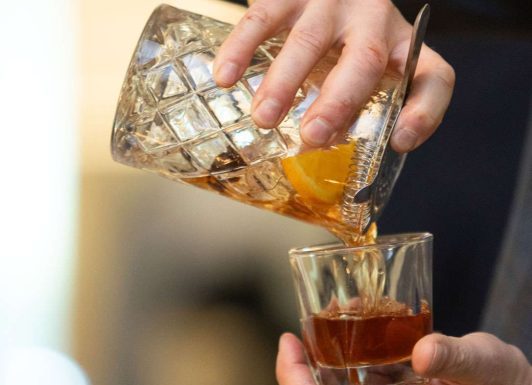 An Old Fashioned being poured