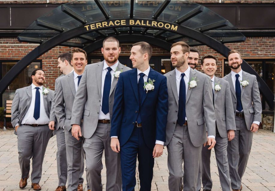 Groom and his groomsmen posting in front of the Terrace Ballroom at Danversport Yacht Club