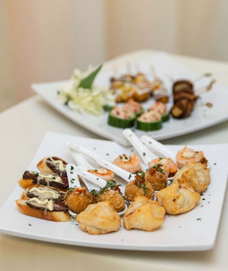 Two plates filled with an assortment of hors d'oeuvres