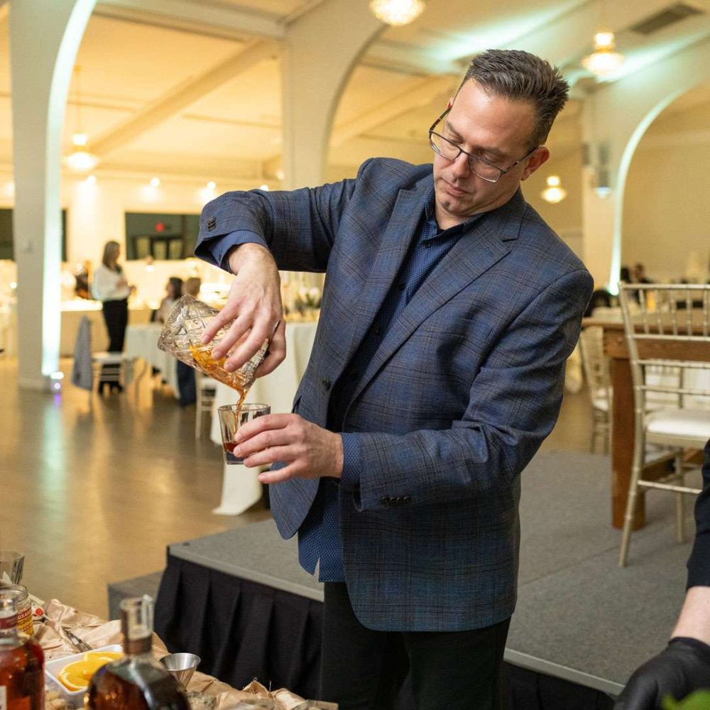 Peter, a Danversport employee, pours an old fashioned